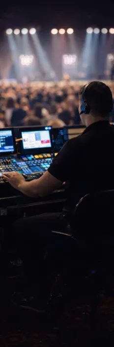 Technician managing lighting and sound during a live event